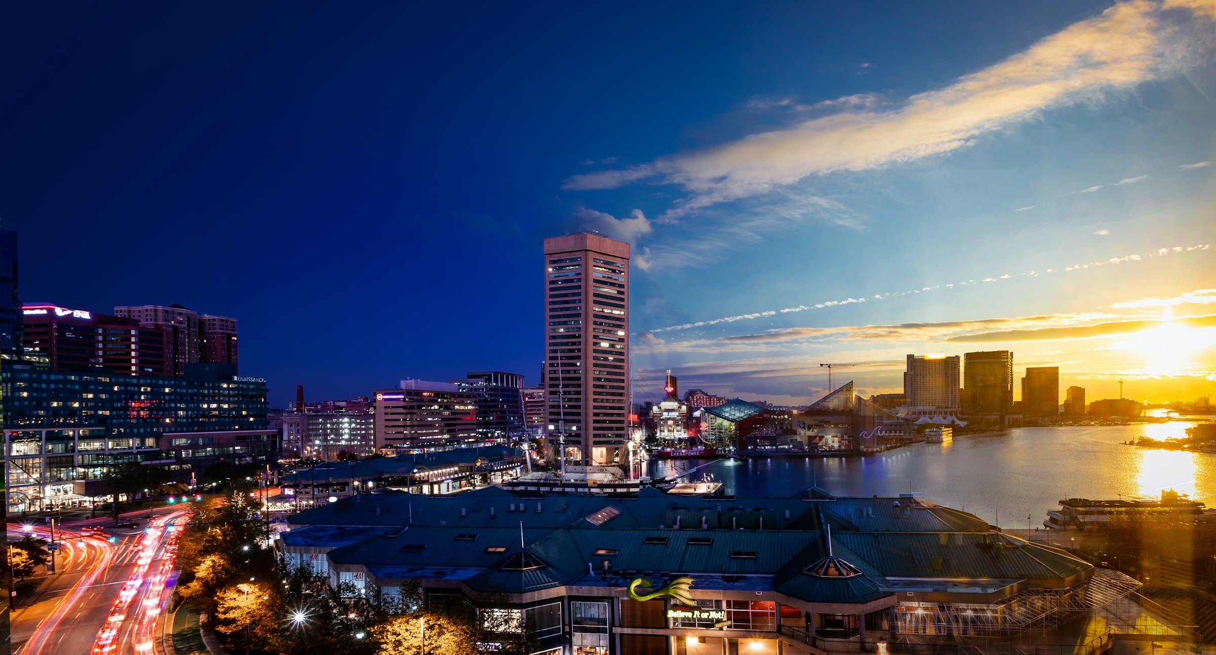 The waterfront skyline of Baltimore's Inner Harbor at dusk.